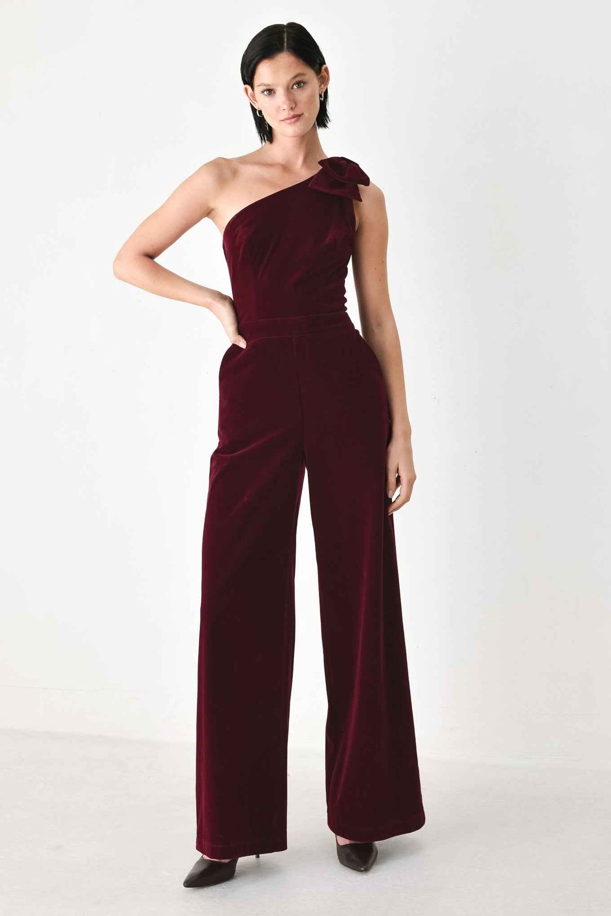 BERRY AFTER DARK VELVET BOW ONE-SHOULDER JUMPSUIT