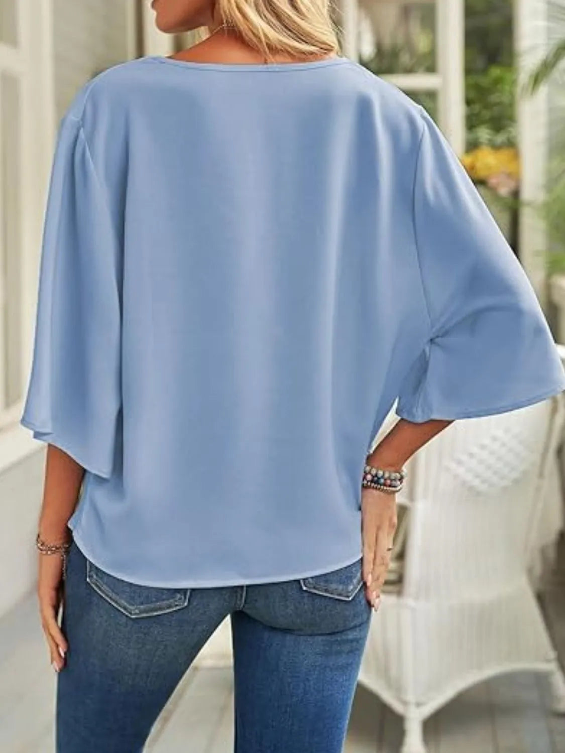 Light blue three-quarter sleeve blouse for women with loose fit and round neckline from Trendsi