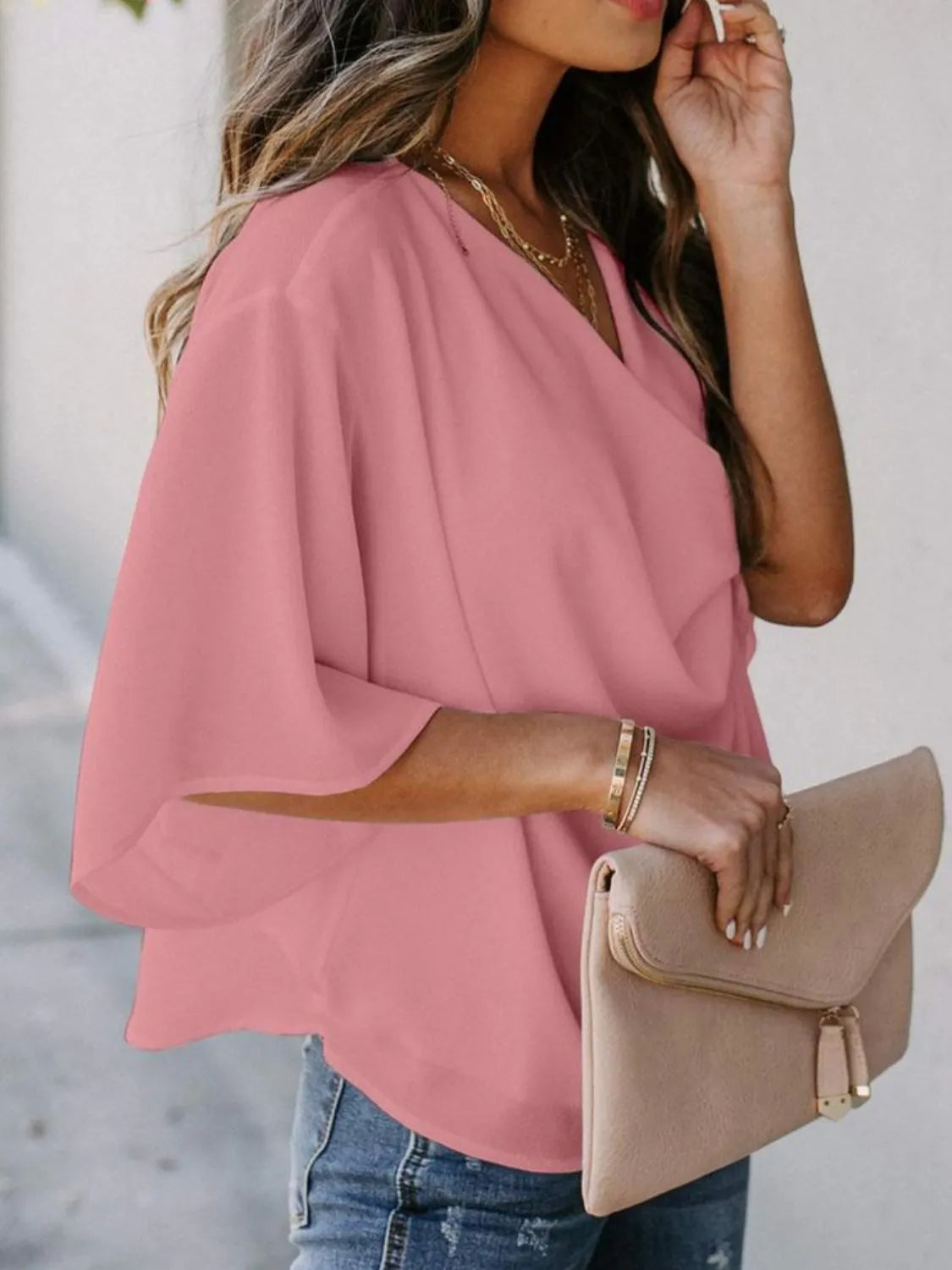Trendsi pink three-quarter sleeve blouse for women styled with light wash jeans and beige clutch