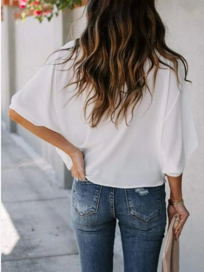 White three-quarter sleeve blouse for women with loose fit shown from back